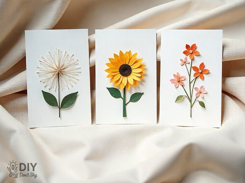 Three handmade cards showing seasonal themes: snowflake, sunflower, and pastel spring design.