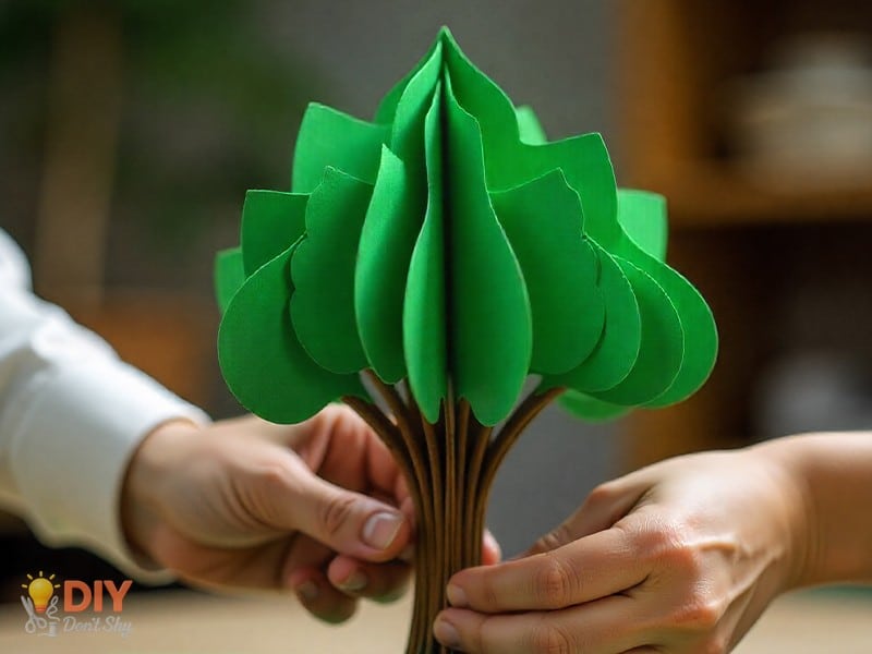 Brown paper rolled into a tube trunk for a 3D paper tree craft.