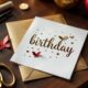 Handmade birthday card for her with craft supplies on wooden table