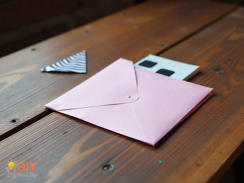 DIY paper heart envelope with self-sealing flap, ready to hold a note.