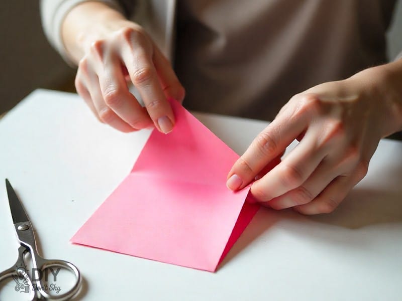 Folding or trimming the extra strip of paper when making an envelope without glue.