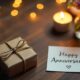 Simple anniversary gift with wrapped present, flowers, and candle