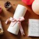 Flat lay of simple last-minute DIY gifts like jars, balloons, scrapbook, and spa kit on a wooden table.