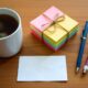 Neatly arranged last-minute teacher gifts with coffee mug, sticky notes, and thank-you card on wooden desk.