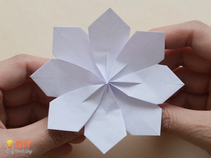 Adjusting folded paper petals to refine the shape of a glue-free flower