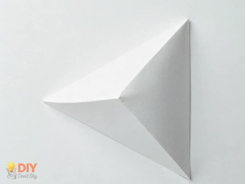 Second inward fold tightening the paper structure for a flower without glue