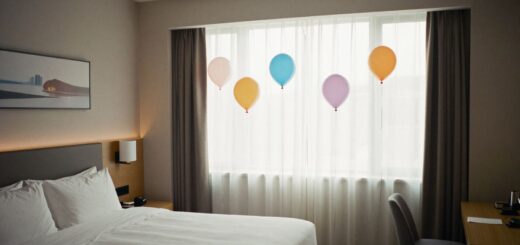Hotel room birthday decoration with balloons, banner, and soft lighting