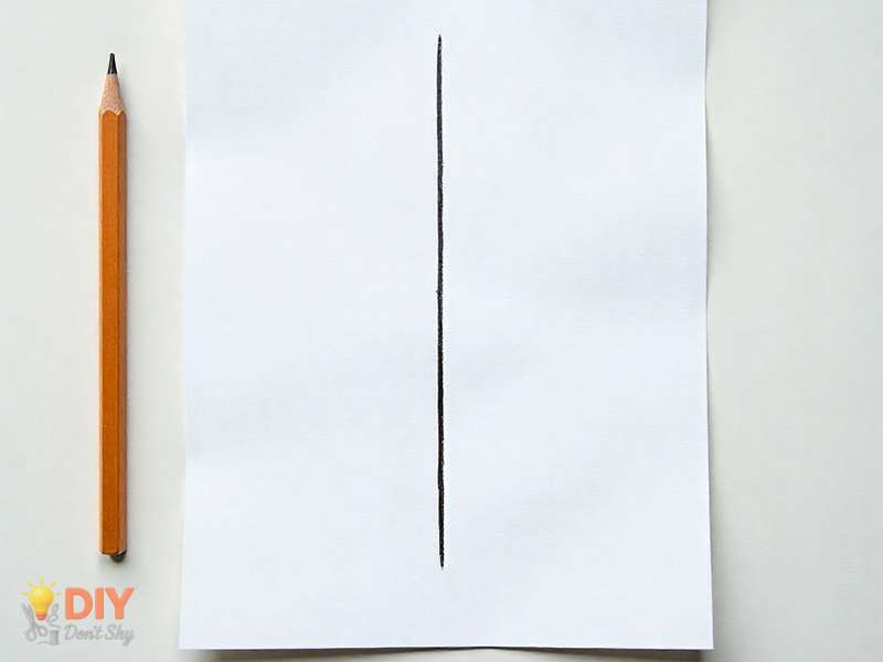 Straight vertical pencil guideline for starting a Valentine heart drawing.