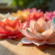 Glue-free paper flowers created using folded paper only, displayed on a wooden table in natural light