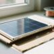 Homemade solar panel made from aluminum foil, copper wire, and cardboard under sunlight.