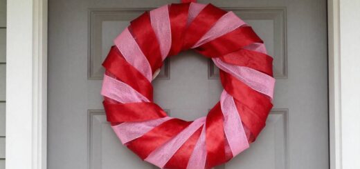 Valentine wreath made with deco mesh and ribbon displayed on a front door