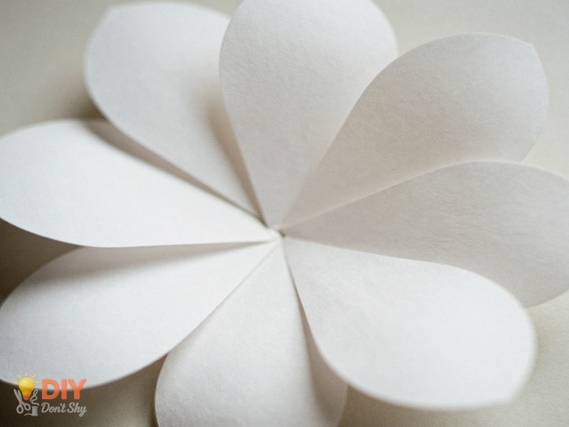 Rounded paper petals formed by gentle pressure using folded paper only