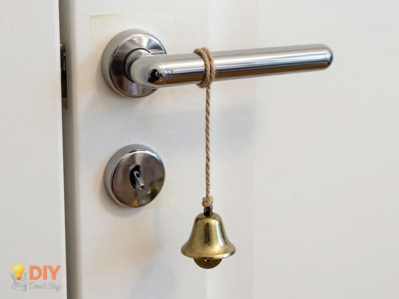 Preparing The Door Setup with string tied to door handle and bell attached