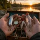Handmade fishing lures made from household items displayed near a lake.