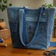 Stylish DIY denim tote bag made from recycled old jeans with sewing tools around